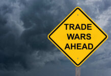Yellow warning sign reads Trade Wars Ahead