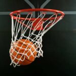 Experimental Treatment FAILS — NBA Icon Dies A basketball going through a hoop with a smoky background