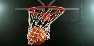 A basketball going through a hoop with a smoky background