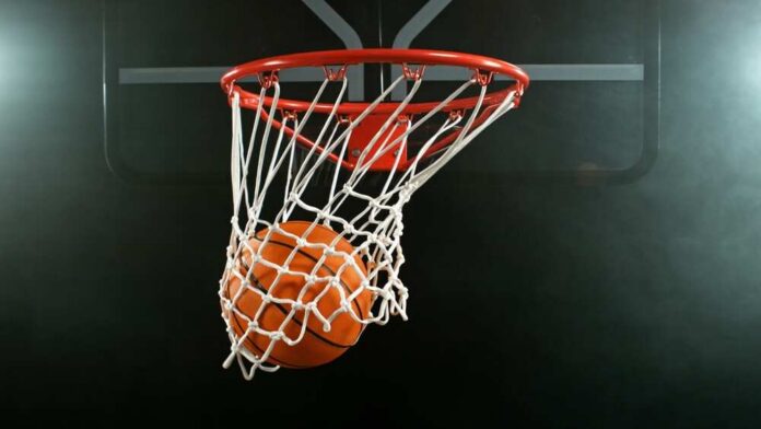 A basketball going through a hoop with a smoky background