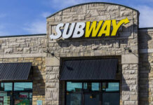 Exterior view of a Subway restaurant with a prominent sign