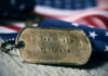 Dog tag and American flag honoring veterans.
