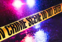 Family Festival Turns Into War Zone Crime scene tape with flashing lights in background.