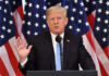 Trump Torches Netanyahu — ‘Crazy’ A man giving a speech with American flags behind.