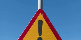 Triangular warning sign with exclamation mark.