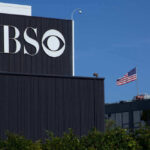 CBS Meltdown: Star Ousted After Explosive Meeting CBS building with American flag in background.