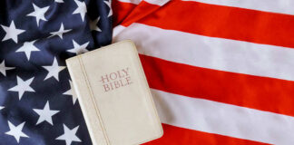 Bible on an American flag background.