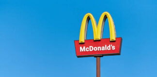 McDonald's restaurant sign against a clear blue sky