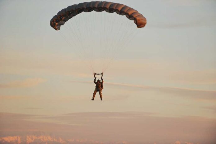 Almaty,,Kazakhstan,-,09.08.2015,:,Soldiers,Of,The,Air,Force Silhouette of a helicopter with two individuals being lowered by ropes