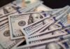 Biggest IPO Ever Makes Him a Trillionaire?! Close-up of scattered hundred dollar bills