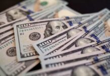 Biggest IPO Ever Makes Him a Trillionaire?! Close-up of scattered hundred dollar bills