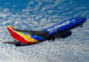 Southwest Backtracks After Special Interest Uproar Southwest airplane on the air with blu sky and white clouds.