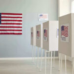 Trump Surge Upends Georgia — Now What? Polling booths with American flags and Vote signs.