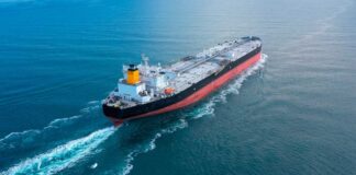 An oil tanker navigating through calm ocean waters