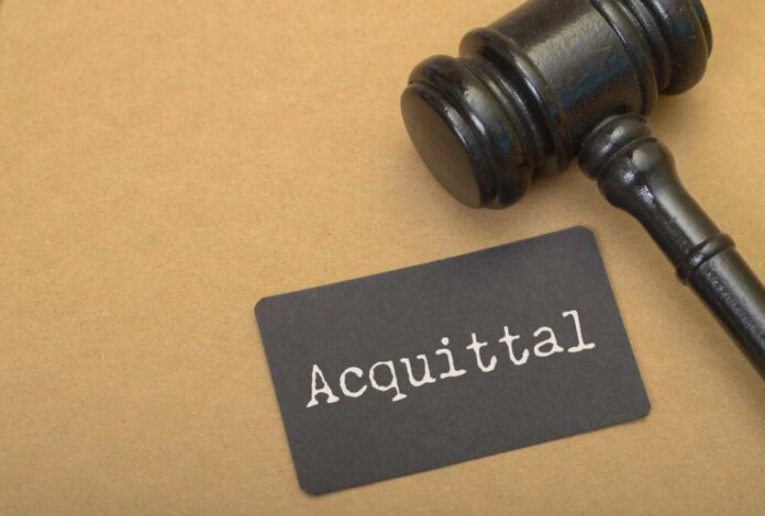 The,Juxtaposition,Of,The,Gavel,And,The,Word,Acquittal,Emphasizes A gavel next to a card that reads 'Acquittal'