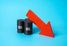 Oil Plunge Aftershock — But What’s Missing? Three black oil barrels with the word 'OIL' and a red downward arrow