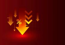 Savings Crash To 2.6% — Uh Oh Graphic representation of downward arrows and a percentage symbol on a red background