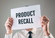 Regulators Sound Alarm On Amazon Product Person holding a sign reading product recall