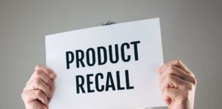 Person holding a sign reading product recall