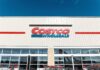 Surprise Price Drop: Costco Quietly Cuts Exterior view of a Costco Wholesale store with shopping carts in front