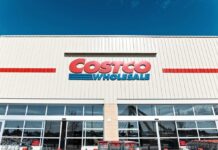 Surprise Price Drop: Costco Quietly Cuts Exterior view of a Costco Wholesale store with shopping carts in front