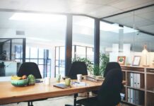 Modern conference room with wooden table and black chairs