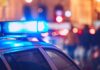Bloody Weekend: 6 Dead, 19 Shot Close-up of a police car with blue emergency lights in a city at night