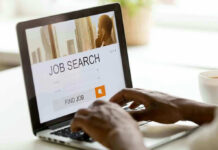 Candy Giant Ditches Blue State After 85 Years Person searching for jobs on a laptop.