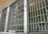 Detention Boom Soars — 43,138 Arrests! Empty prison cell with metal bars and toilet.