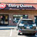 DQ Grill & Chill restaurant exterior with stone facade and red awnings