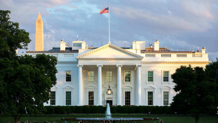 shutterstock_1819595129 The White House with Washington Monument in background.