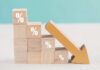 Wall Street Stunned: Inflation Breaks Trend Wooden blocks with percent signs and a downward arrow