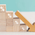 Wooden blocks with percent signs and a downward arrow