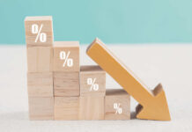 Wall Street Stunned: Inflation Breaks Trend Wooden blocks with percent signs and a downward arrow