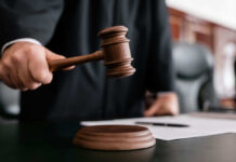 Tesla Trunk Horror: Pop Star Put On Trial Judge holding gavel in courtroom.