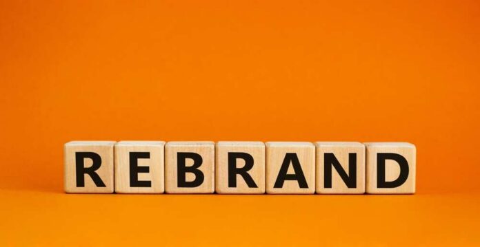 Rebrand,And,Brand,Symbol.,The,Concept,Word,Rebrand,On,Wooden Wooden blocks spelling the word 'REBRAND' on an orange background
