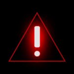 Red warning triangle with exclamation mark on black background