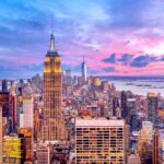 Airborne Killer Hits New York City Empire State Building amid New York City skyline at sunset