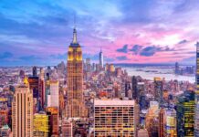 Airborne Killer Hits New York City Empire State Building amid New York City skyline at sunset