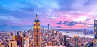 Empire State Building amid New York City skyline at sunset