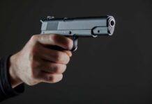 VIDEO: Gunfire Erupts — Officers Shot, 1 Killed Hand holding a semi-automatic pistol pointed forward