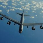Strategic B-52 bomber aircraft flying over the ocean