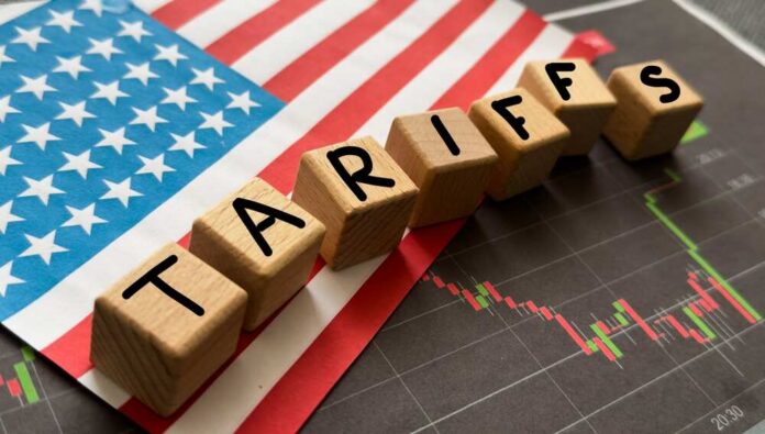 Container,Tariffs,Word,On,Flag,Of,The,United,States,Of Wooden blocks spelling 'TARIFFS' on a background of the US flag and financial charts