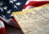 Supreme Court Drops Bombshell Decision Close-up of a historical document with the American flag in the background