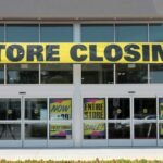 Storefront with a large 'STORE CLOSING!' banner and sale signs