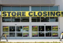 Storefront with a large 'STORE CLOSING!' banner and sale signs