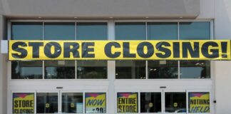 Storefront with a large 'STORE CLOSING!' banner and sale signs