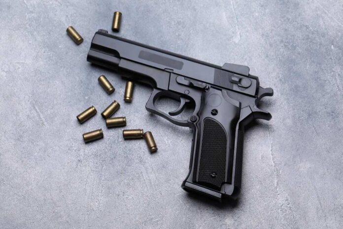 Bullets,And,Gun,On,Grey,Table,,Flat,Lay