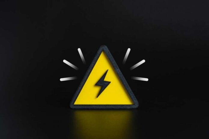 A yellow triangular warning sign with a lightning bolt on a black background