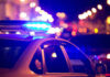 VIDEO: Open Container Bombshell Rocks Romo Case Police car with blue lights flashing at night.